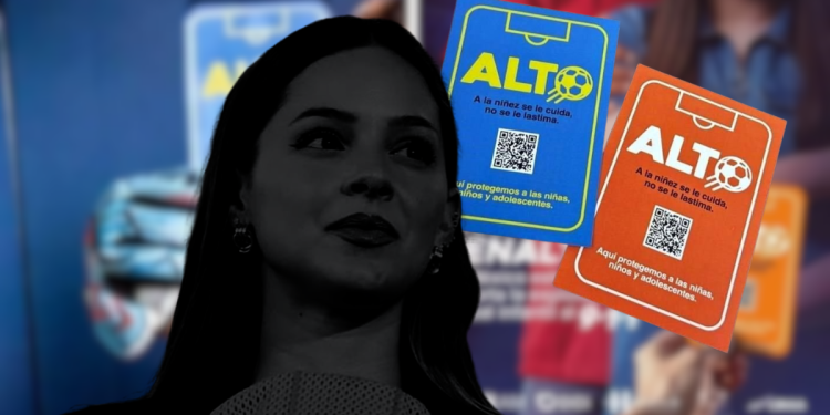Silhouette of a Woman in the Foreground with Blue and Orange Alto Posters About Protecting Children in the Background. - Enbroncados