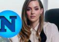 Portrait of a Woman in an Office Setting, with a Large Blue Circular Logo Featuring a Bold N over Her Left Side. - Enbroncados