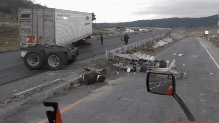 Semi-trailer Obstructing a Curved Highway with Scattered Debris and Damaged Guardrails; Two People Assess the Scene, with a Truck Side Mirror Visible in the Foreground. - Enbroncados